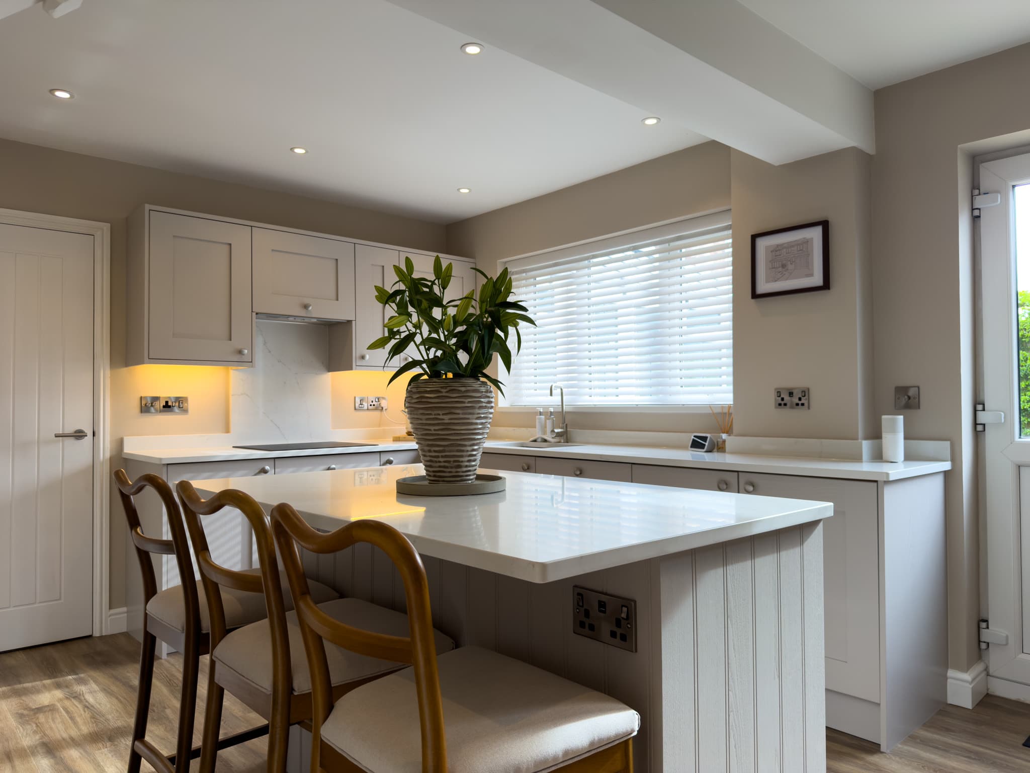 A finished TJO kitchen with white cabinetry and a central island